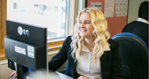 onlinelearning Female wearing black blazer sat at computer