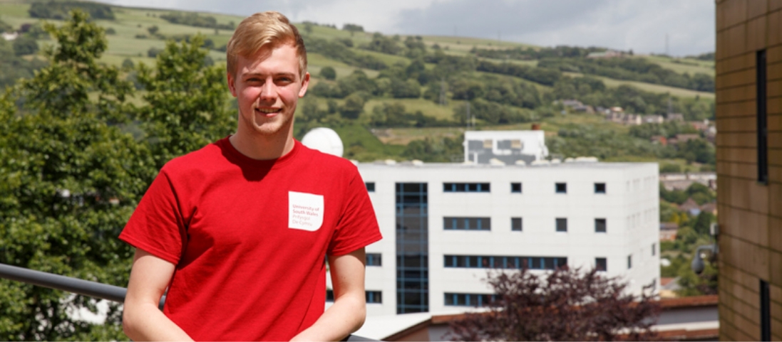 universityofsouthwales USW student on roof with building/hill background