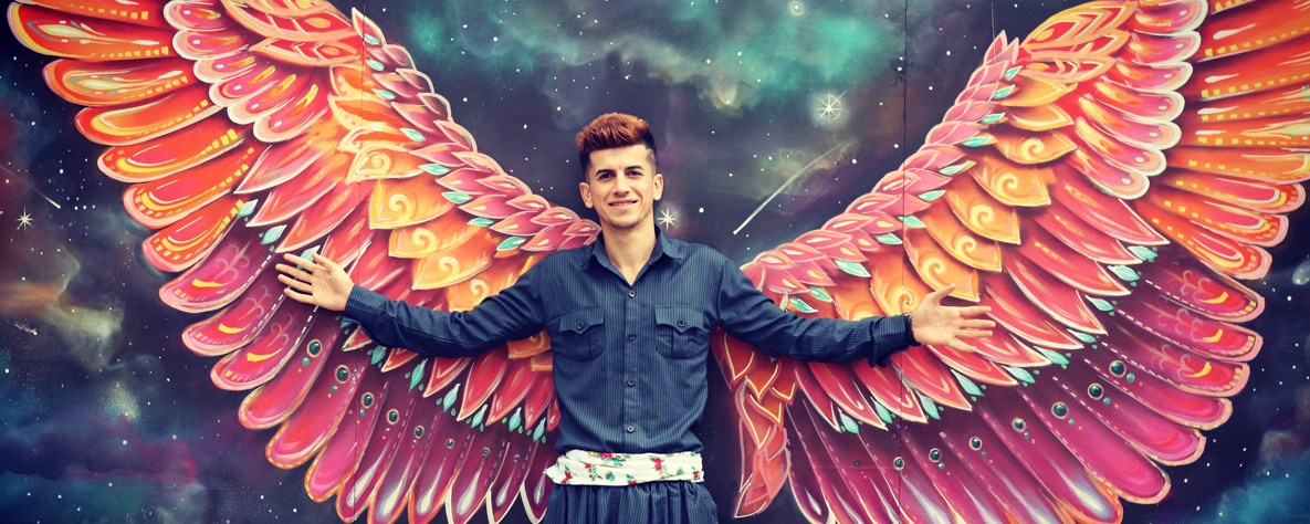 Spirituality student in front of wall art