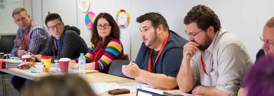 Staff members mid group discussion