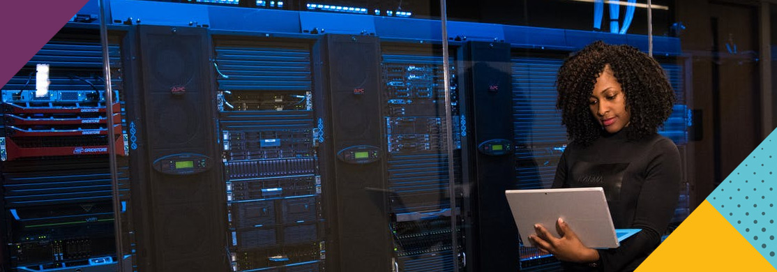 cloud-computing-sector-header Woman using laptop in front of server racking