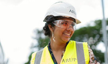 Woman in hard hat, hi-vis and safety glasses