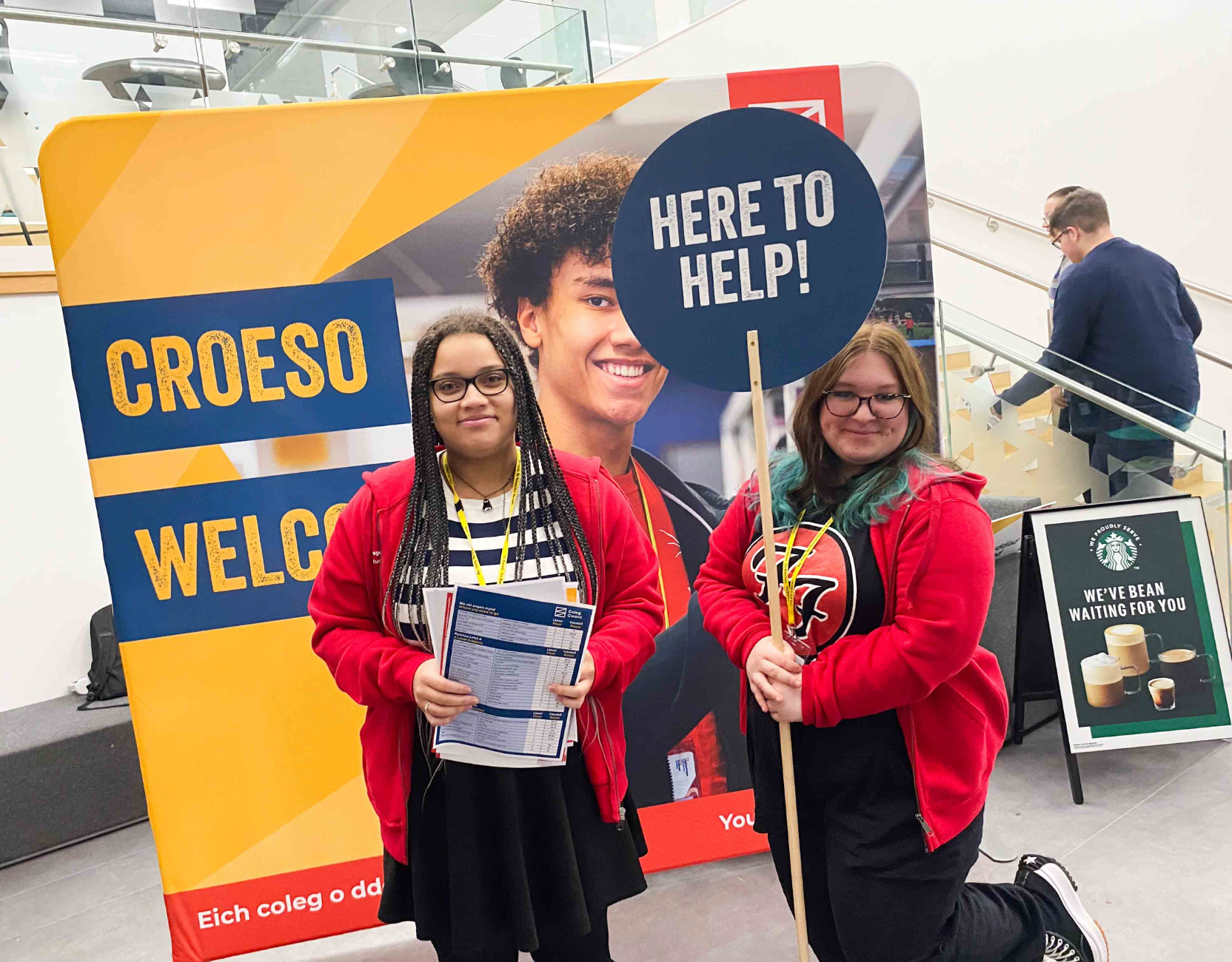 Learners with 'here to help' sign