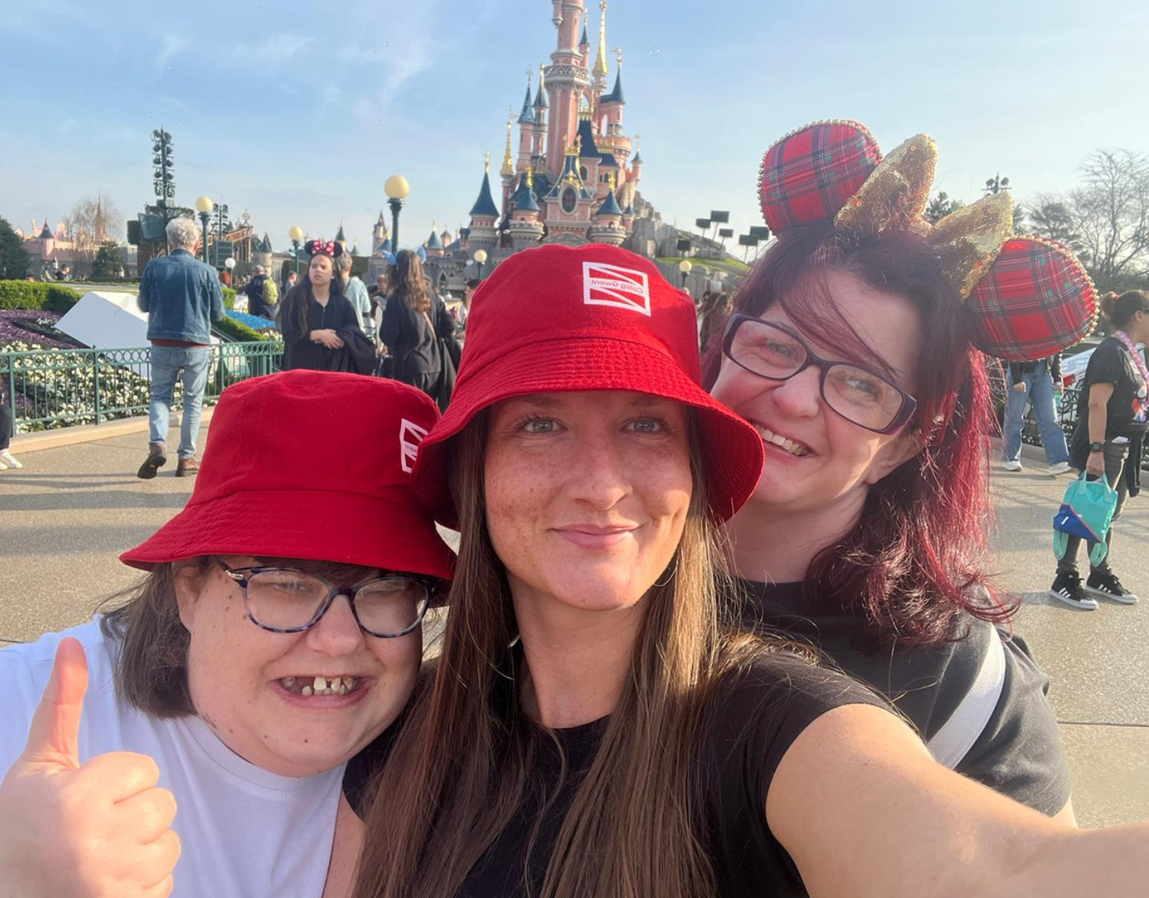 Three women smiling at screen