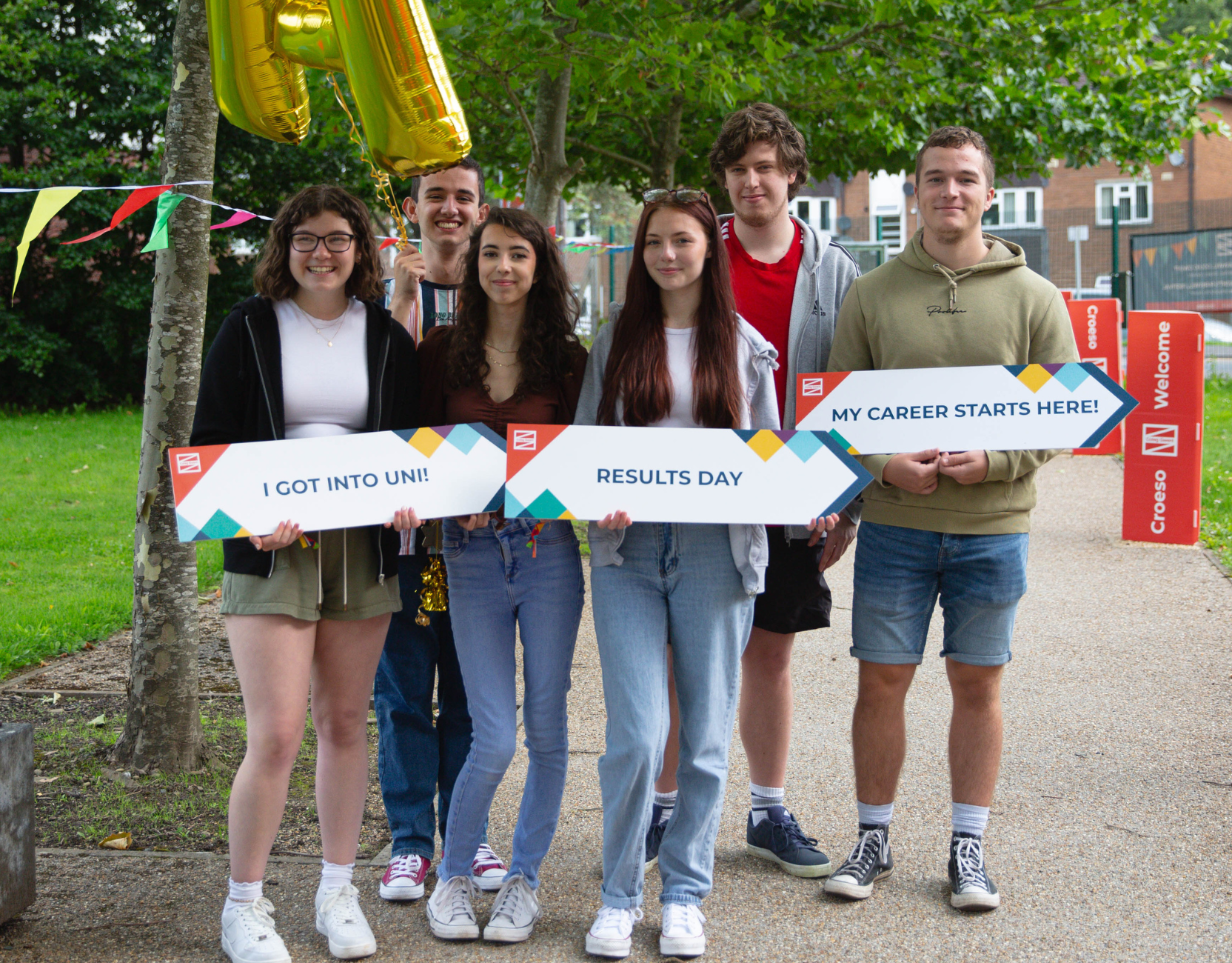 Learners holding Results Day signs