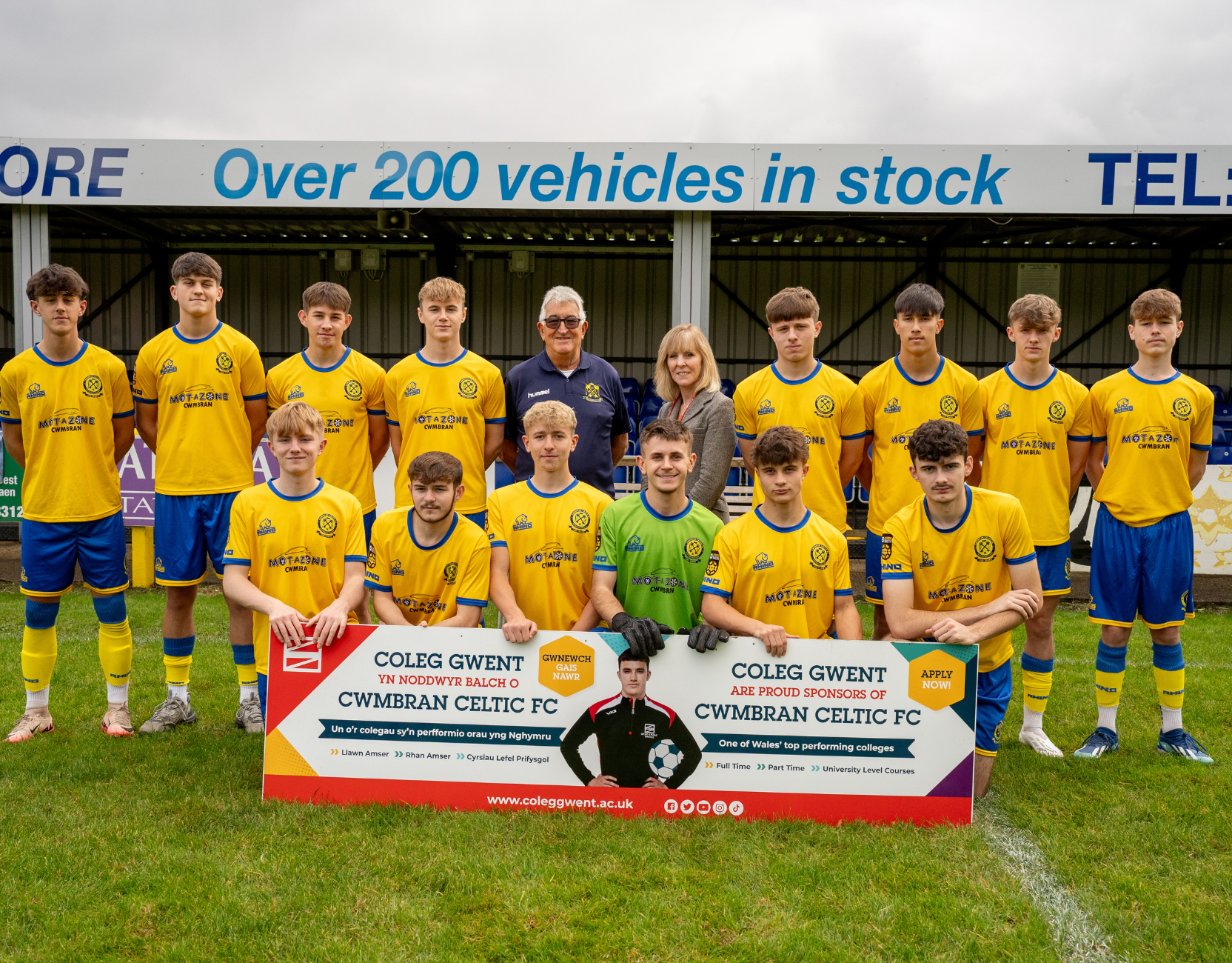 Football players holding a sign
