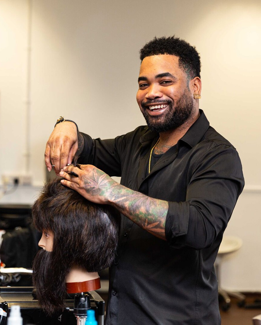 Barbering student cutting hair