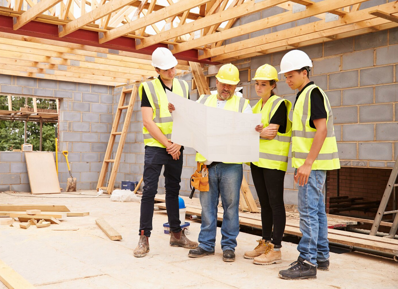 Construction workers looking at plan on site