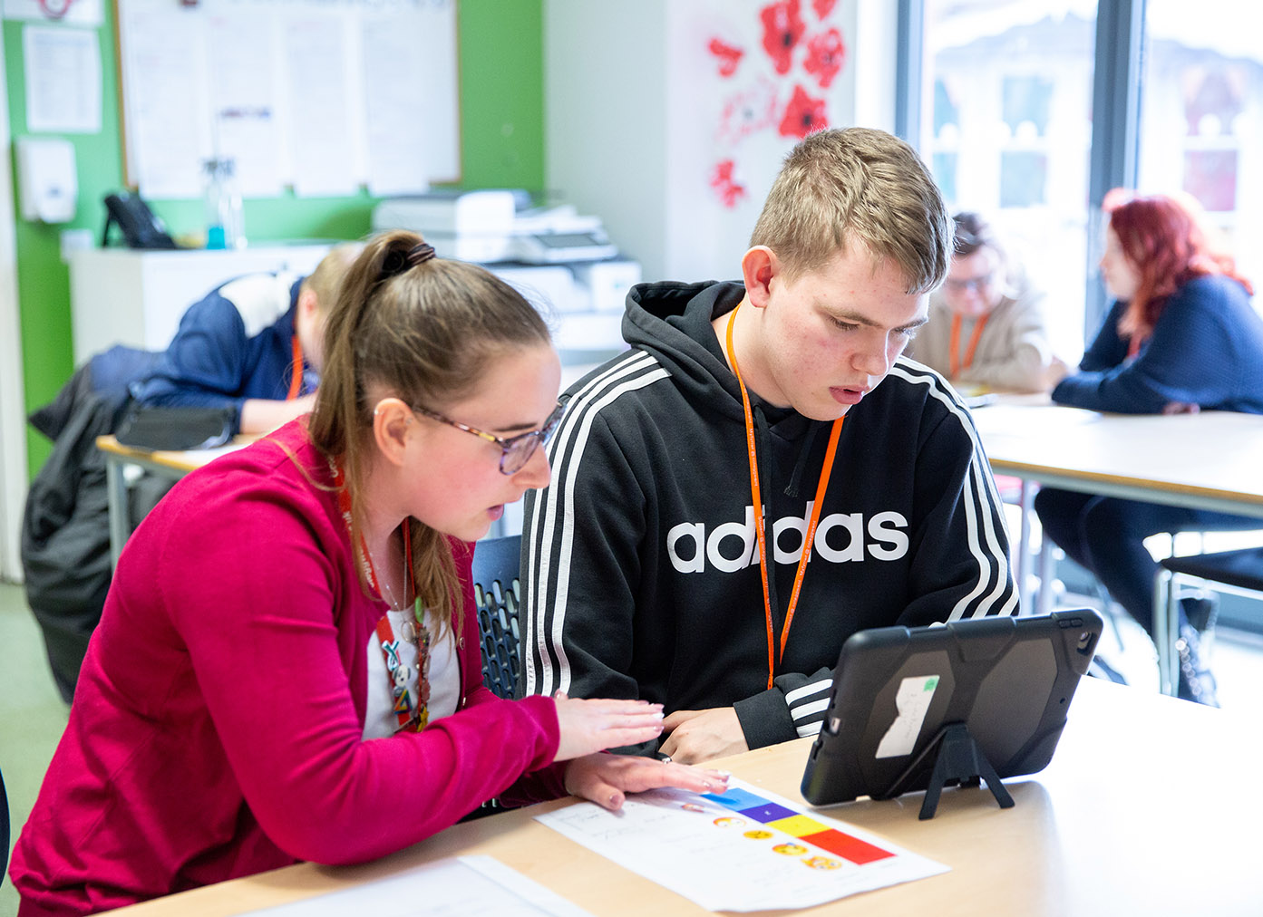 ALN staff supporting student on device