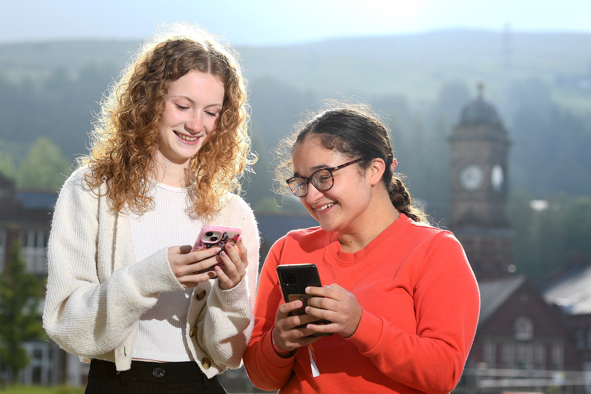 students smiling at phone