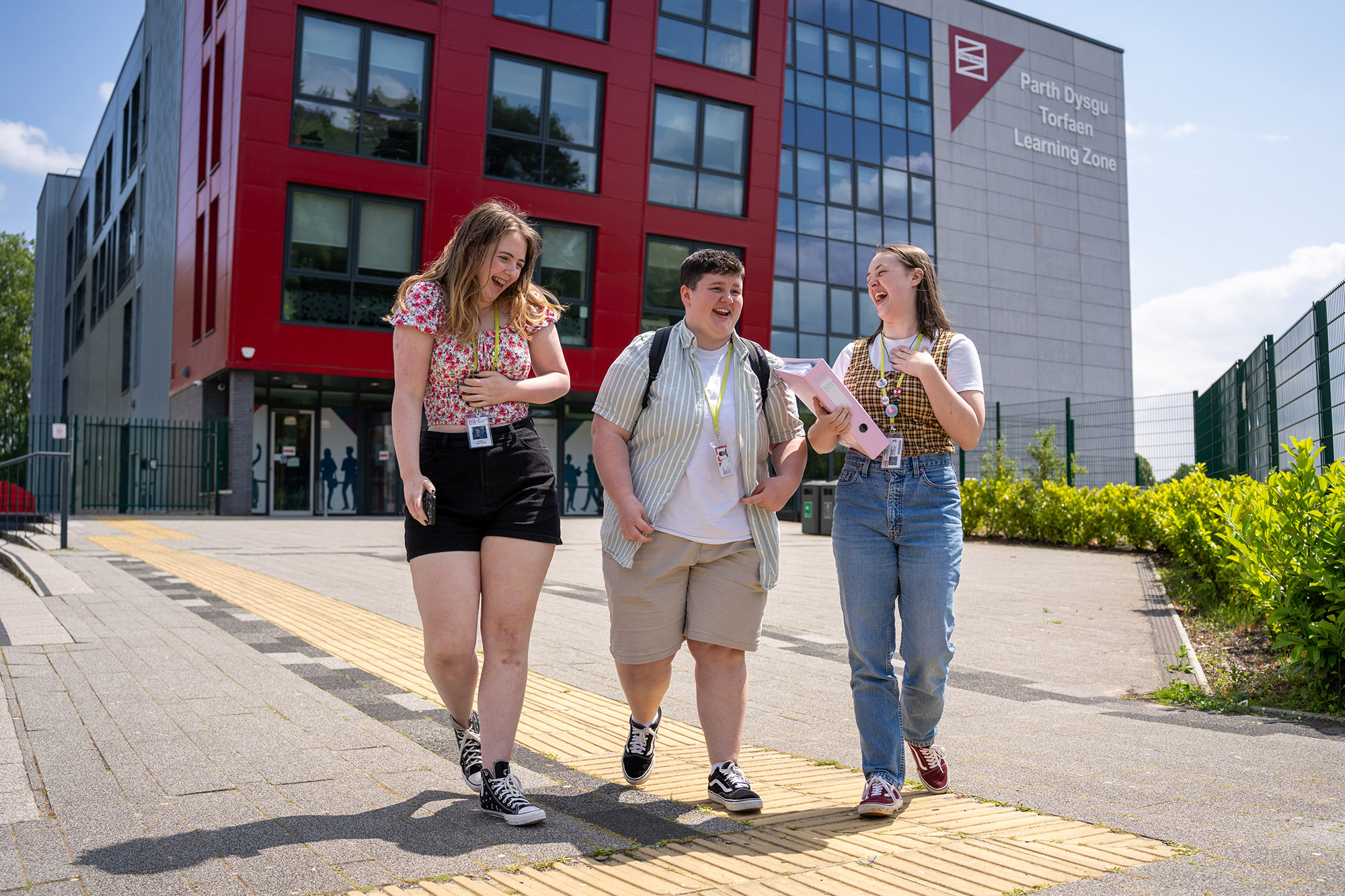Three students walking outside of Torfaen Learning Zone.