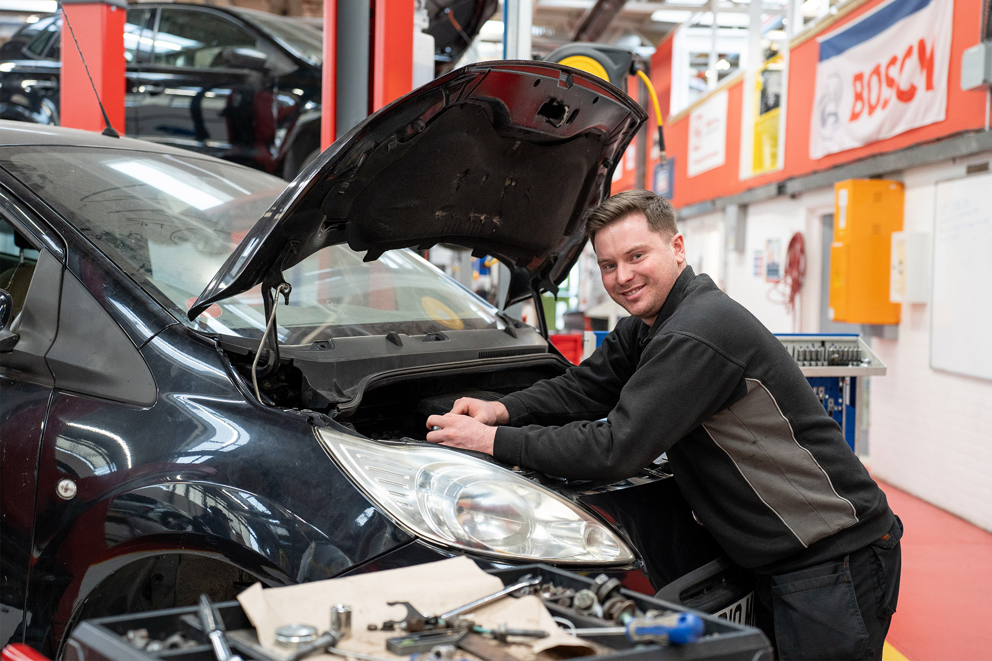 Learner working on a car