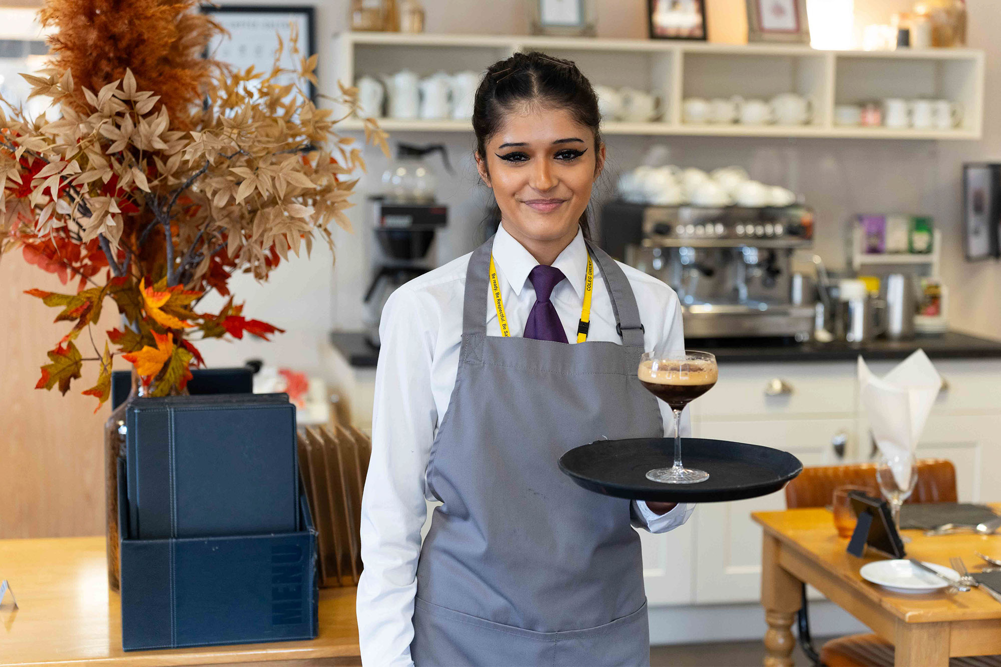 Student with drink at Morels Restaurant