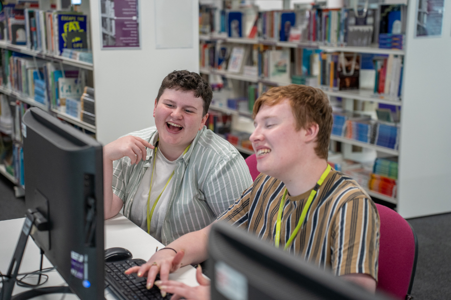 Students laughing whilst studying at TLZ library