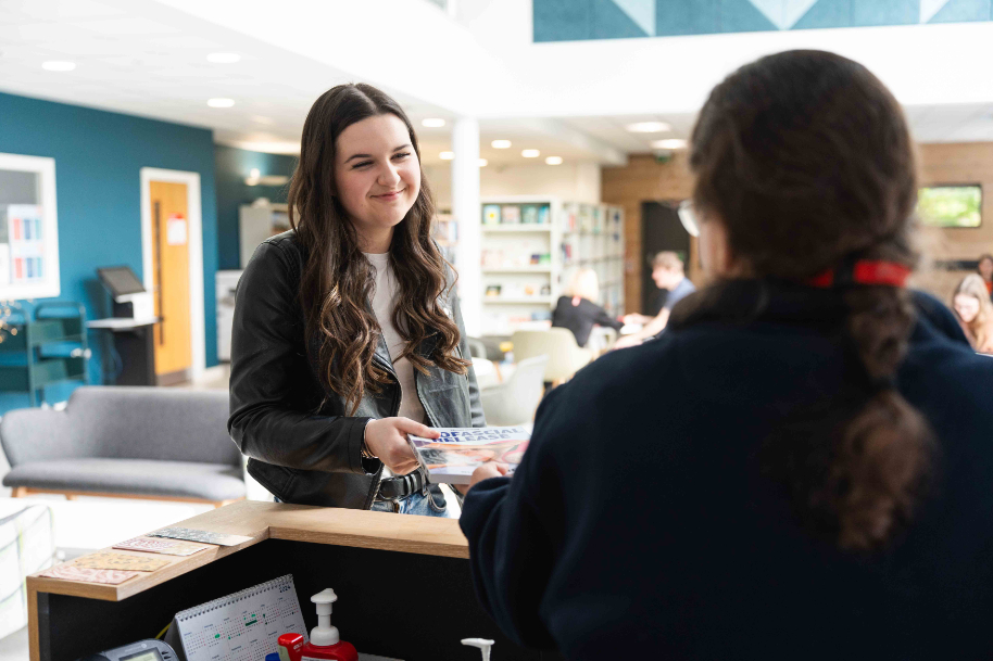 Students at Usk library reception desk