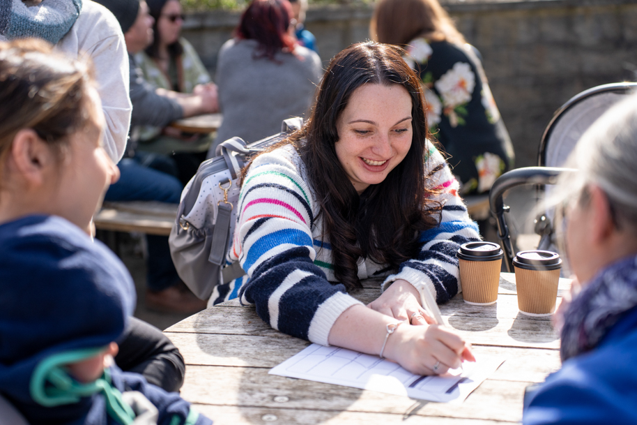 Welsh for adults student doing quiz outside