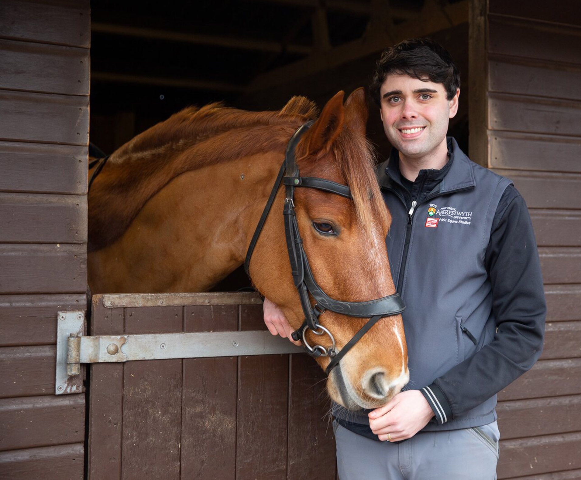 HE student smiling with horse