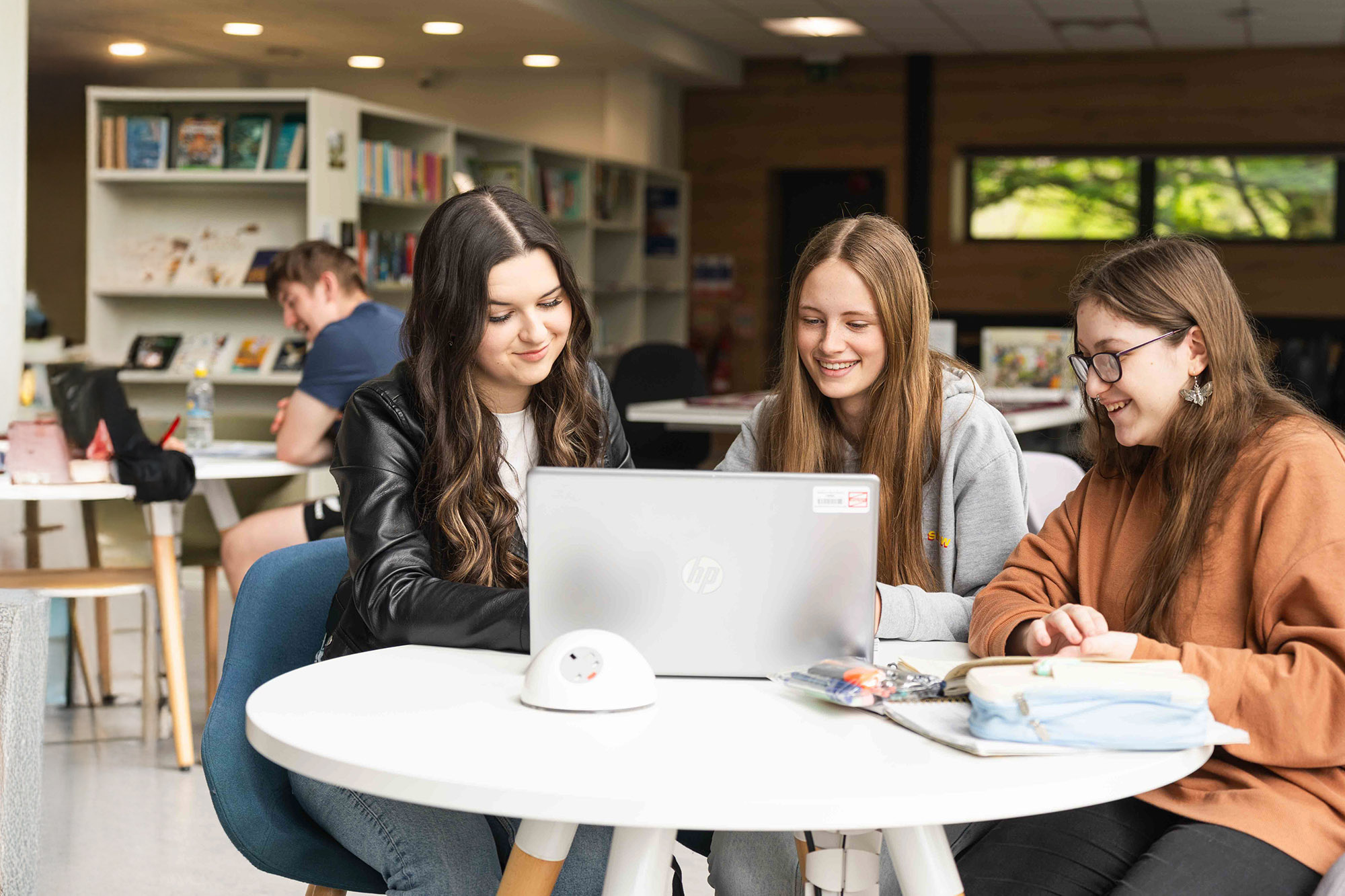 Group of three students studying at Usk library
