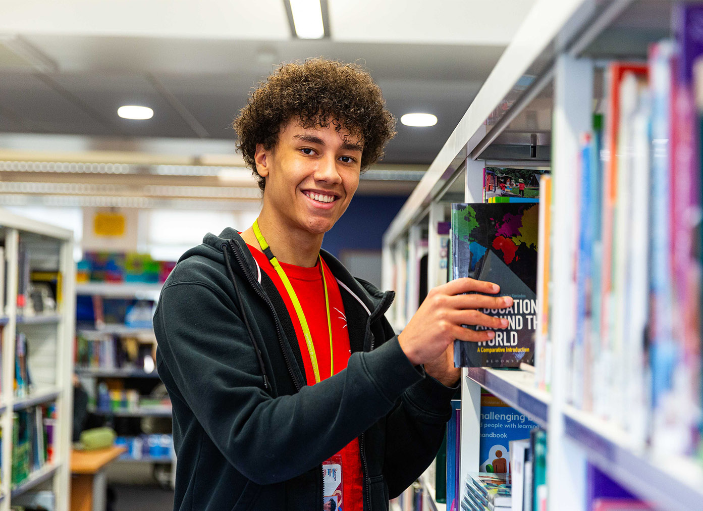 Male-Student-picking-up-book