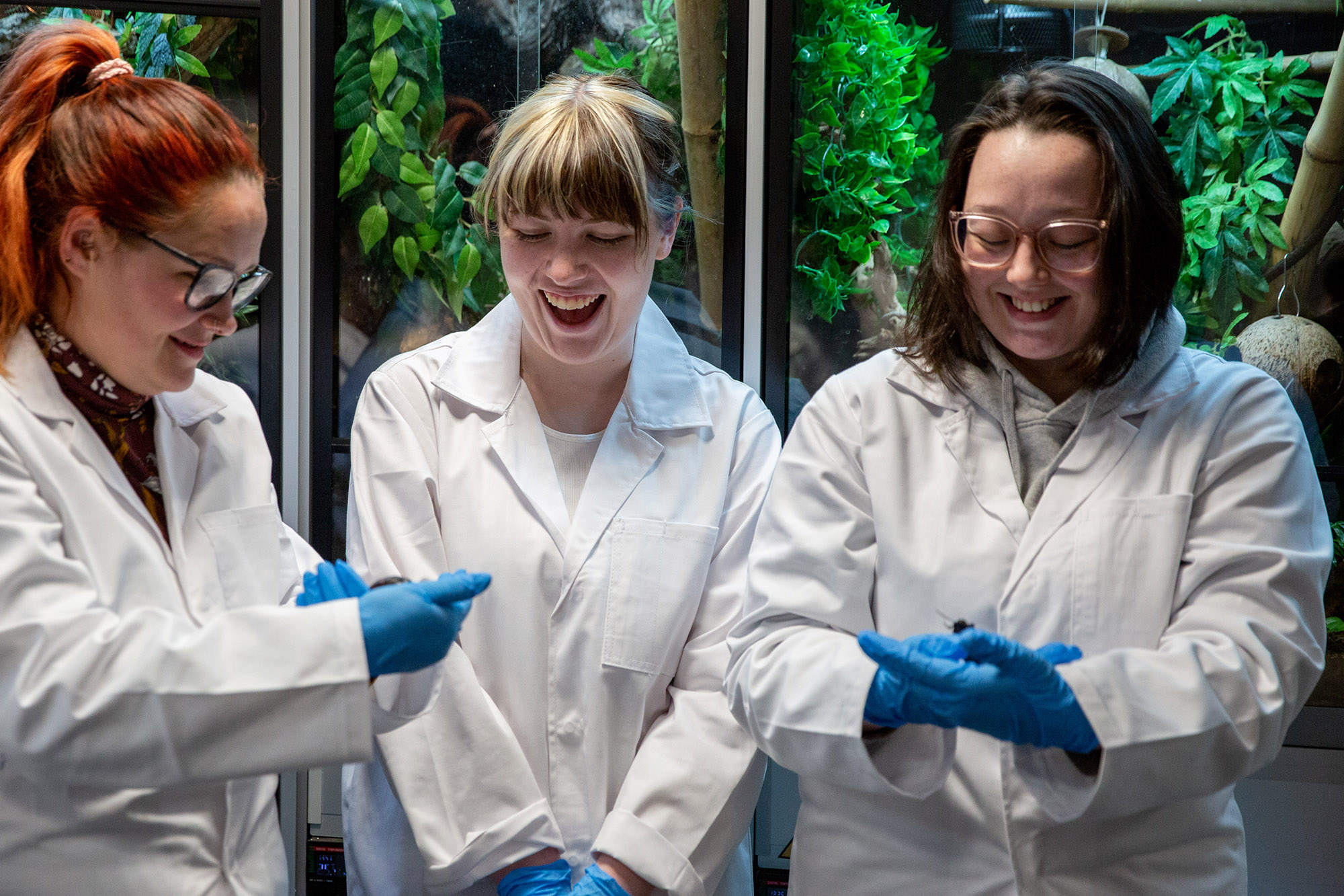 Animal care learners holding animals