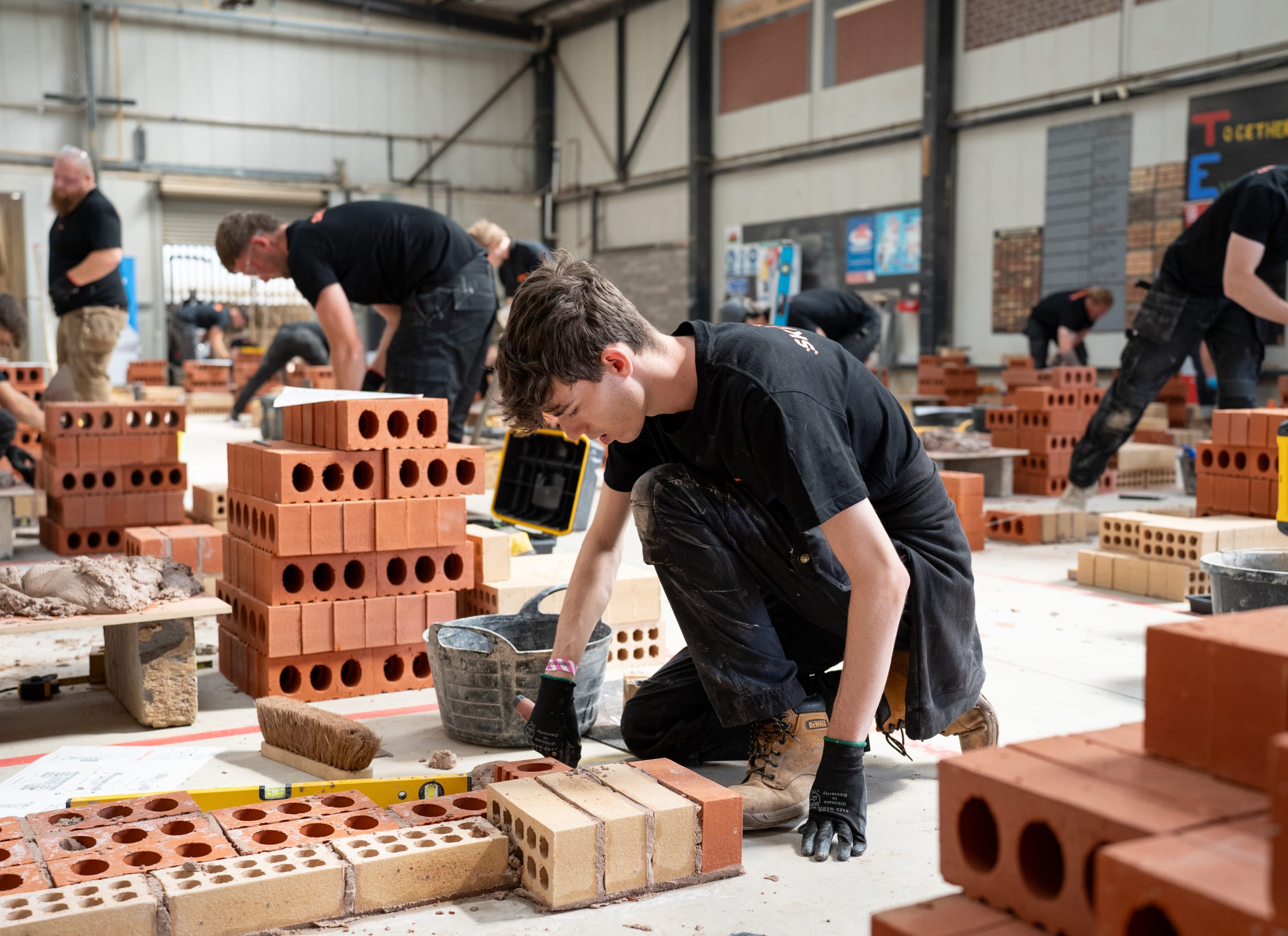 Student laying bricks