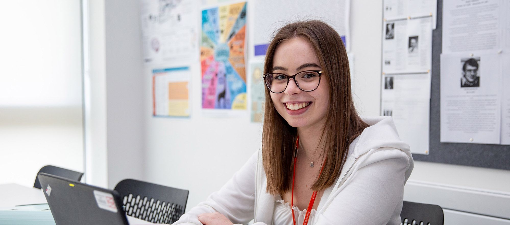 A level student using a laptop in class