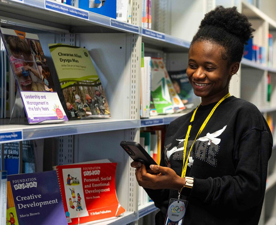 Student at the library in Newport campus