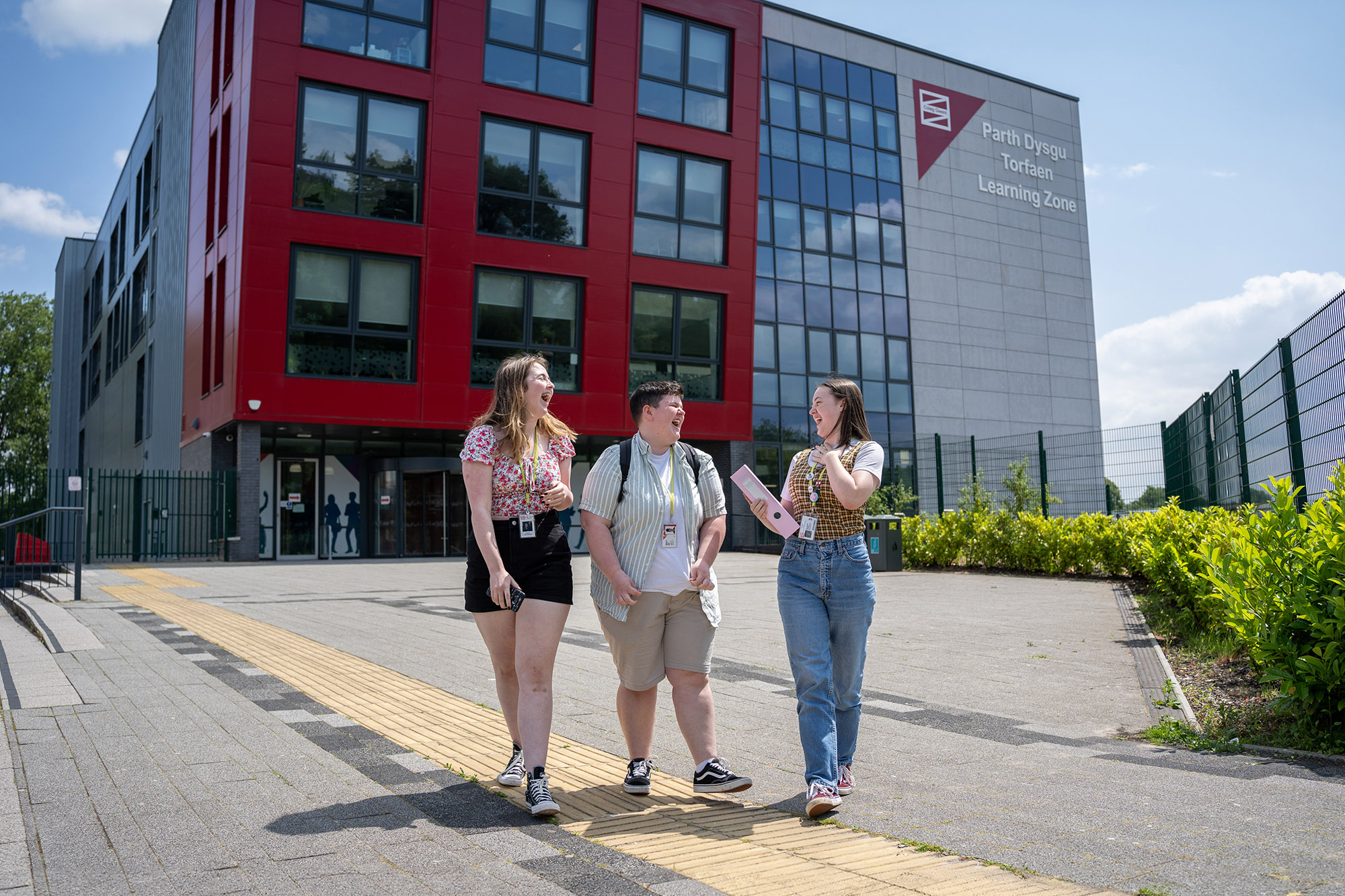 Students walking and talking outside TLZ campus