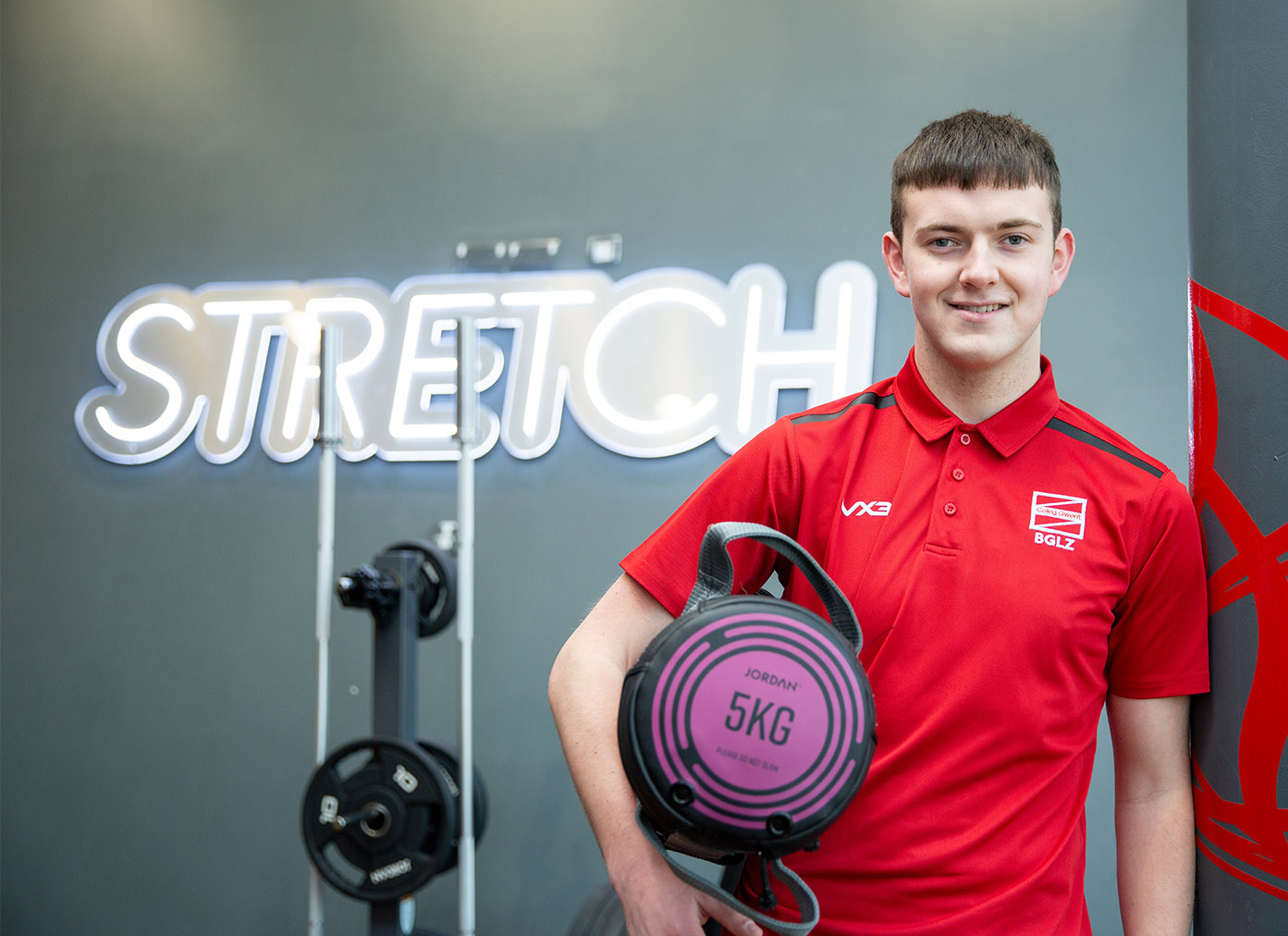 Sport student in the gym holding weights