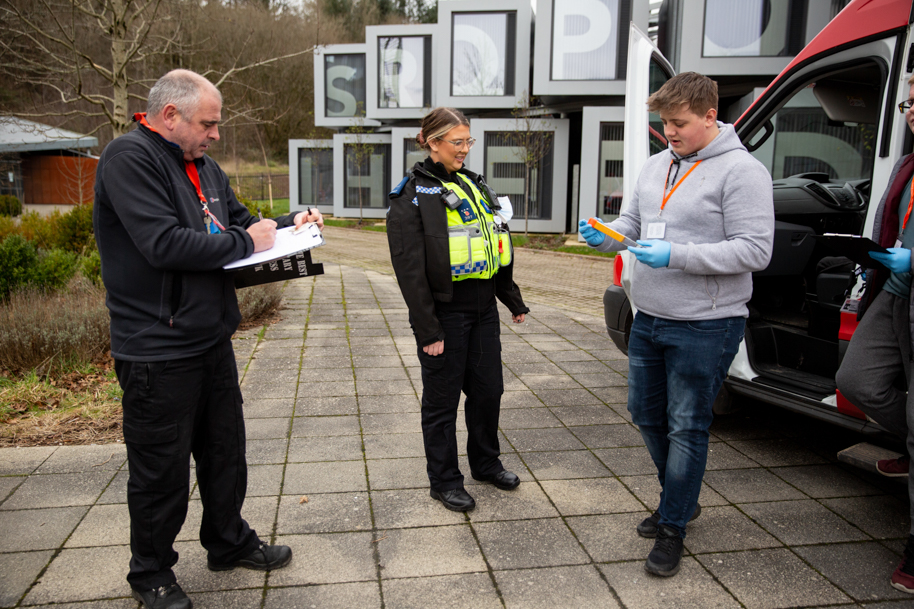 Students talking to tutor and police