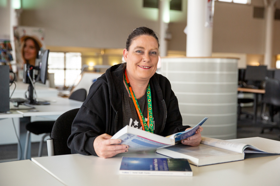 Mature student reading textbook