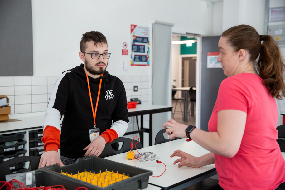 tutor and science student working together