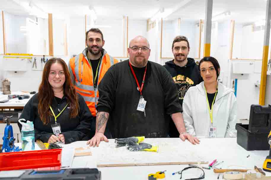Basic Household maintenance students and tutors smiling