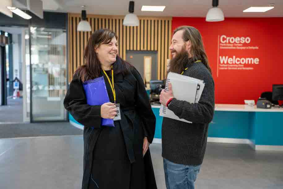 Mature students laughing in college reception
