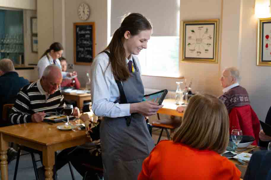 Hospitality student waitressing in Morels restaurant