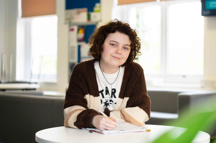 Student studying in the HE Hub