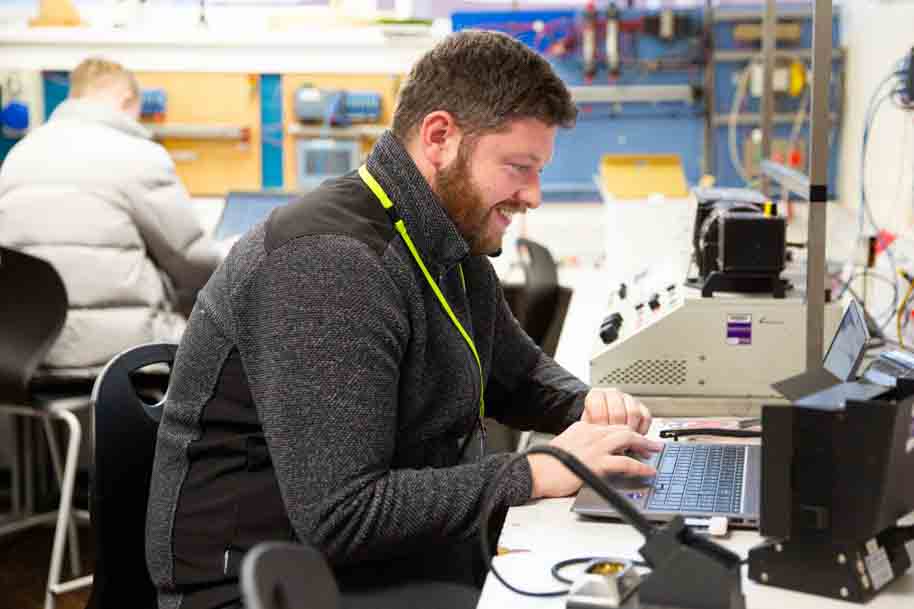 Mature Electrical Engineering student on laptop