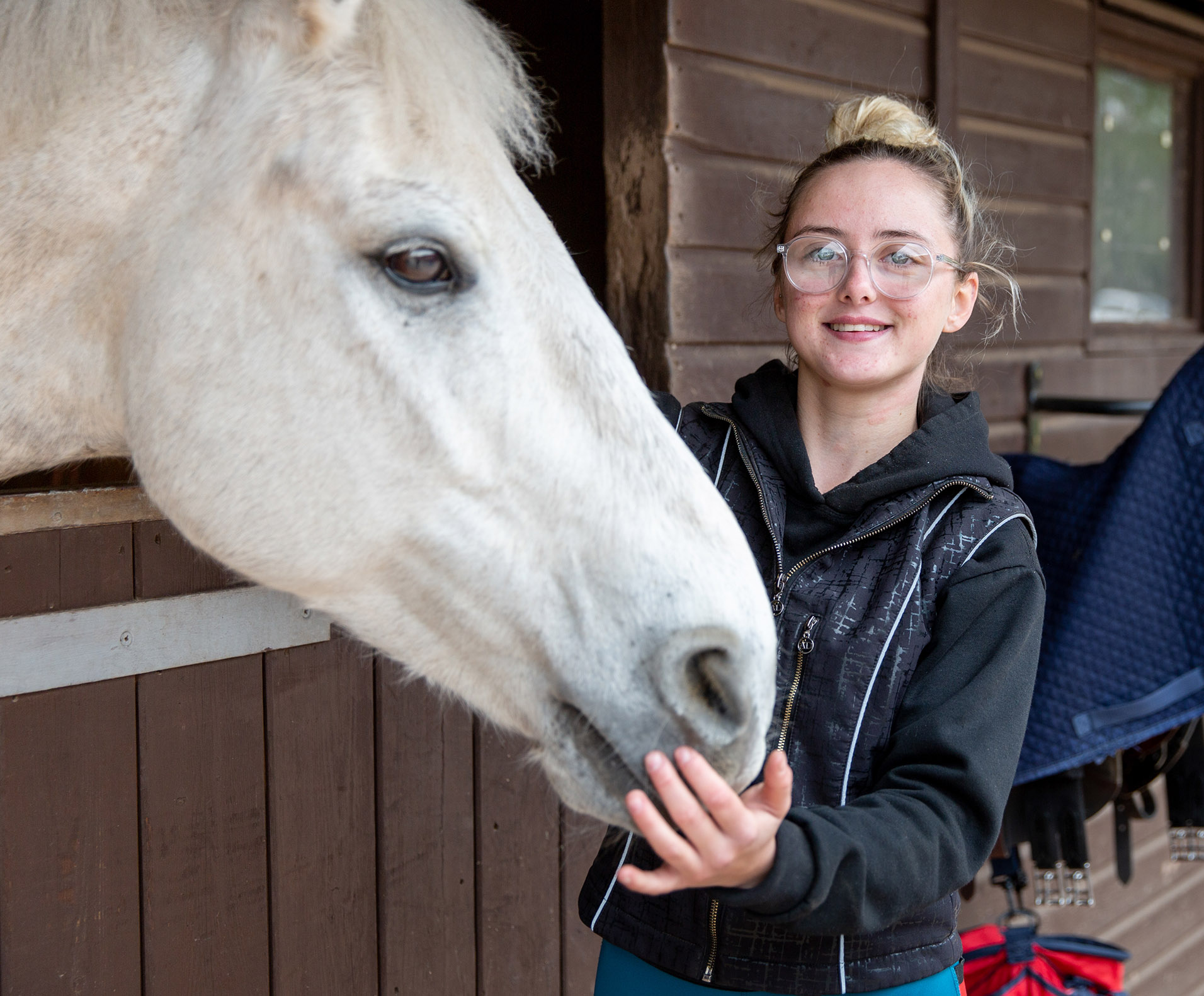 Equine student with horse at stables