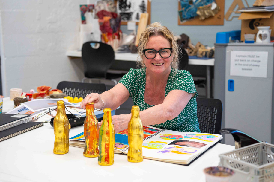 Mature student studying art in classroom