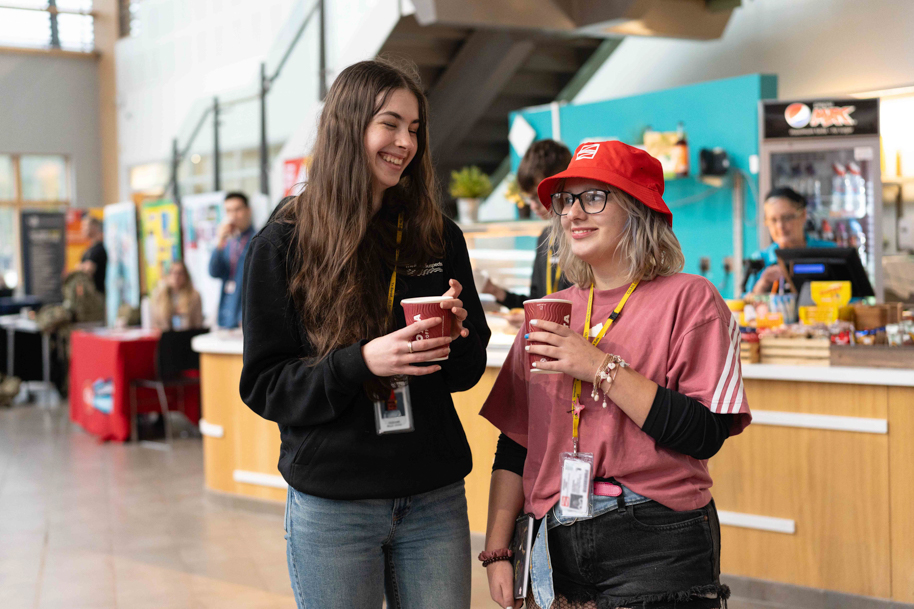 Two students drinking costa at college