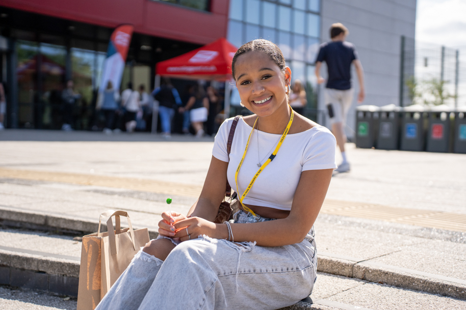 Student smiling on bench
