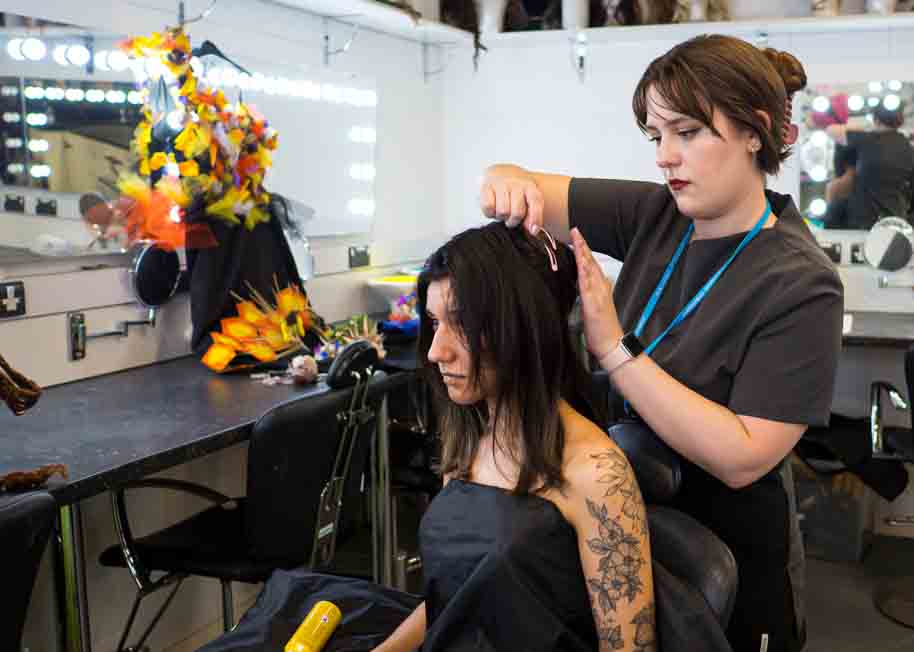 Hairdressing student cutting hair