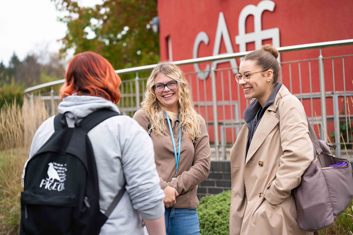 Smiling students outside the Caffi in Usk