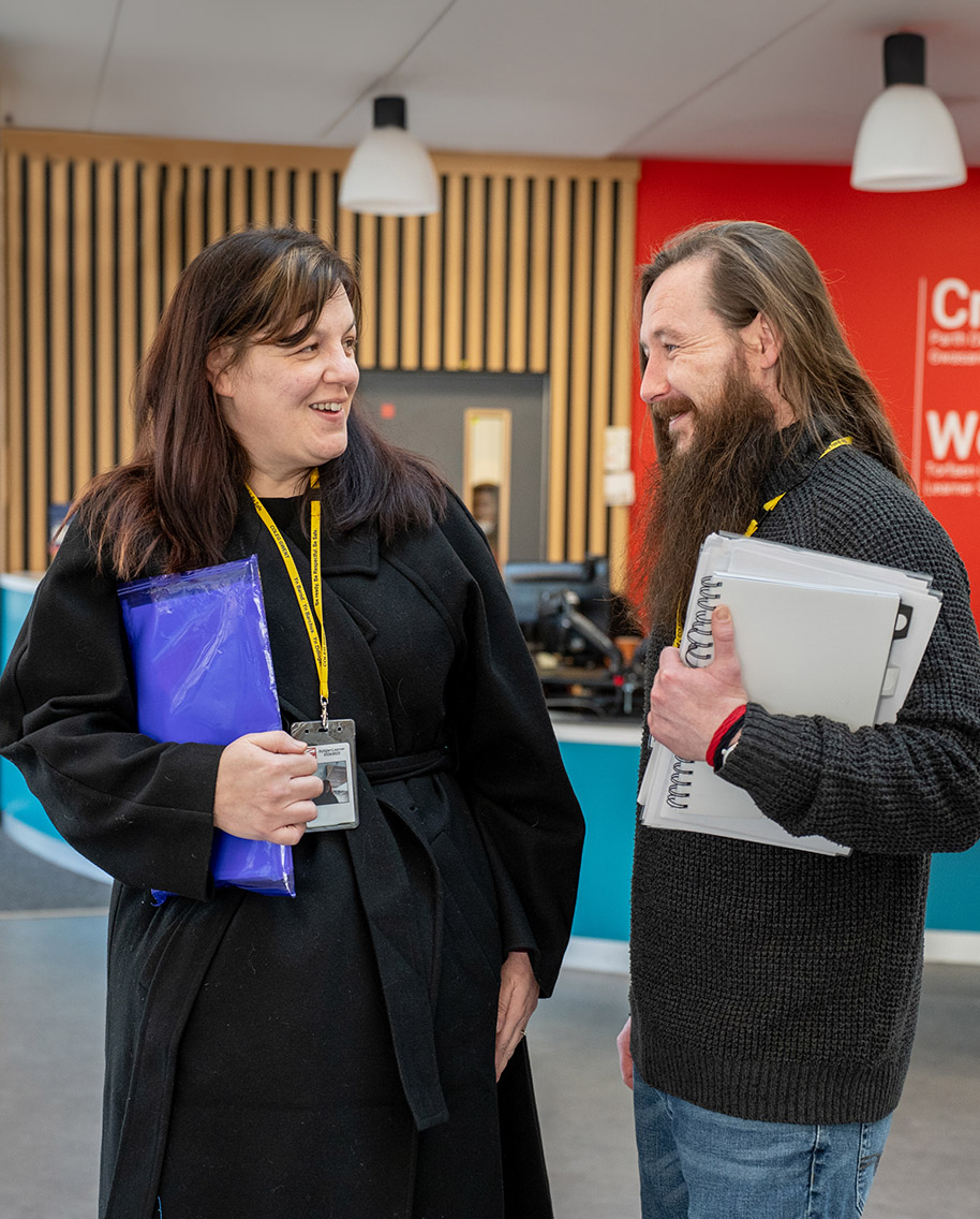 Two adult students chatting at TLZ