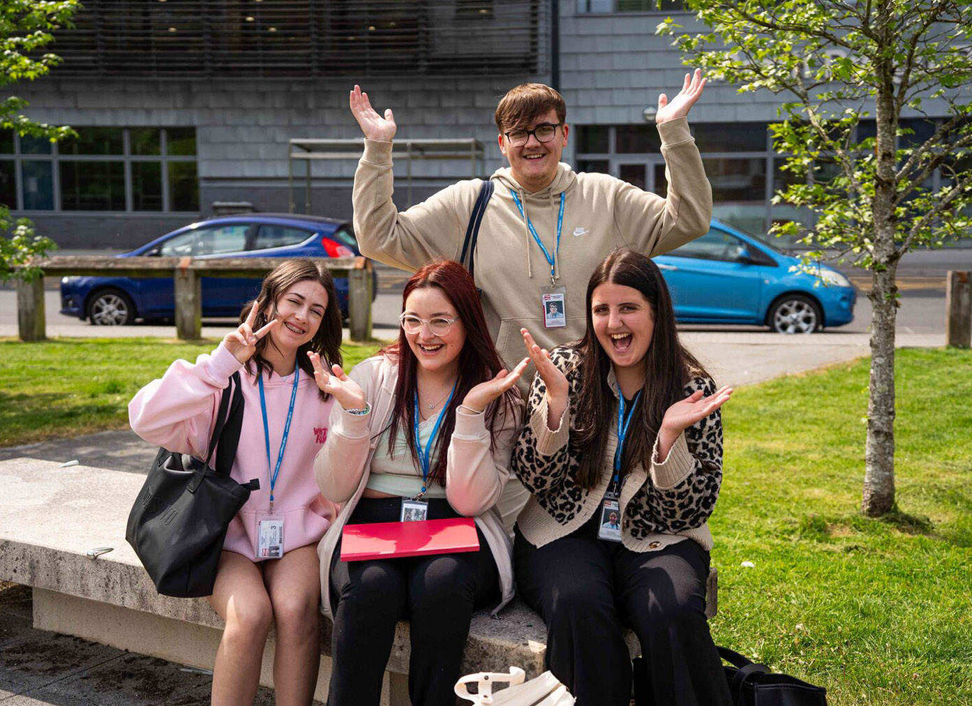 Students smiling and waving hands