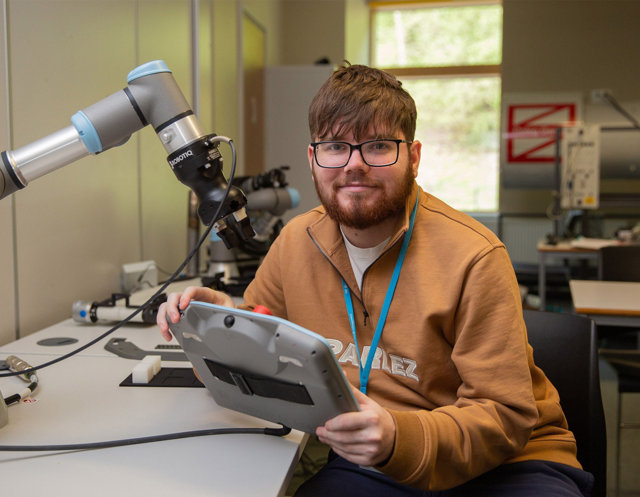 Engineering student working with a robotic arm