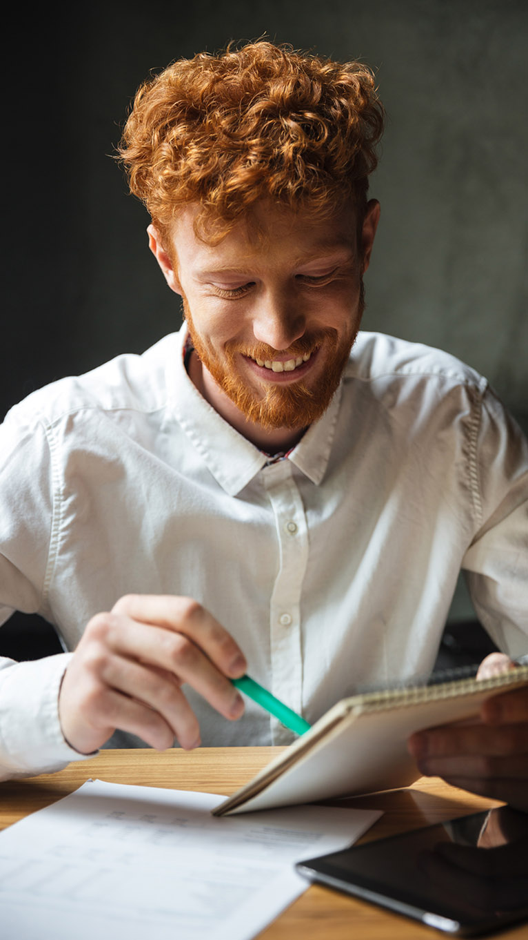 Man writing notes on a notepad