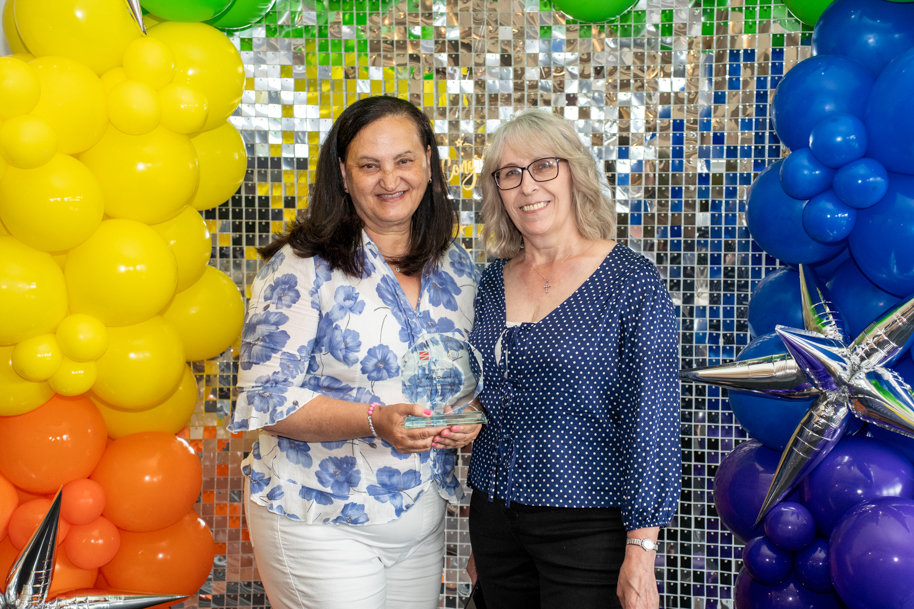 Adult learners holding an award