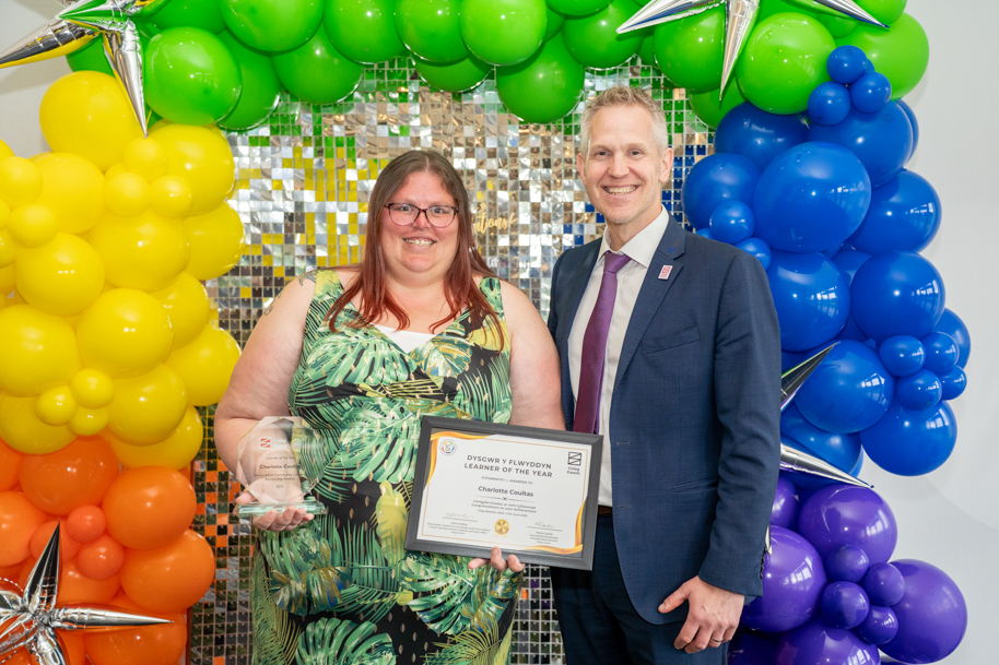 Adult learners holding an award