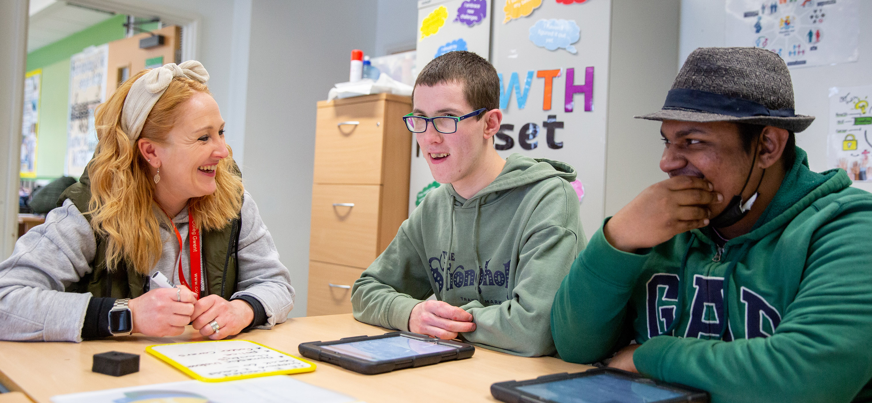 ILS students in class working on tablet devices